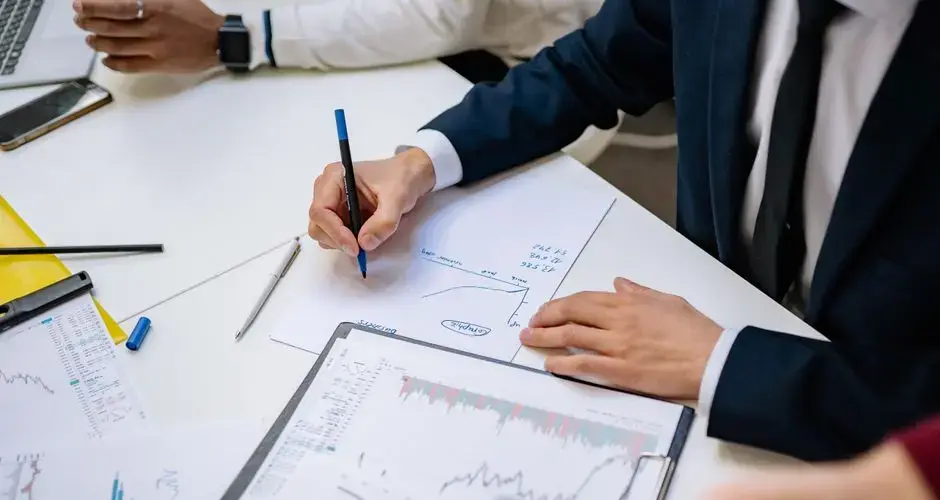 Professionals analyzing financial charts in a corporate setting.