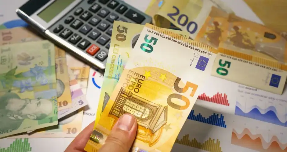 Euro and Romanian Lei currency with calculator on a financial desk setup.