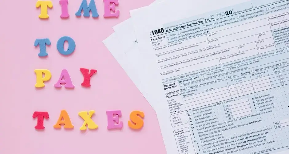 1040 tax forms with colorful 'Time to Pay Taxes' letters.