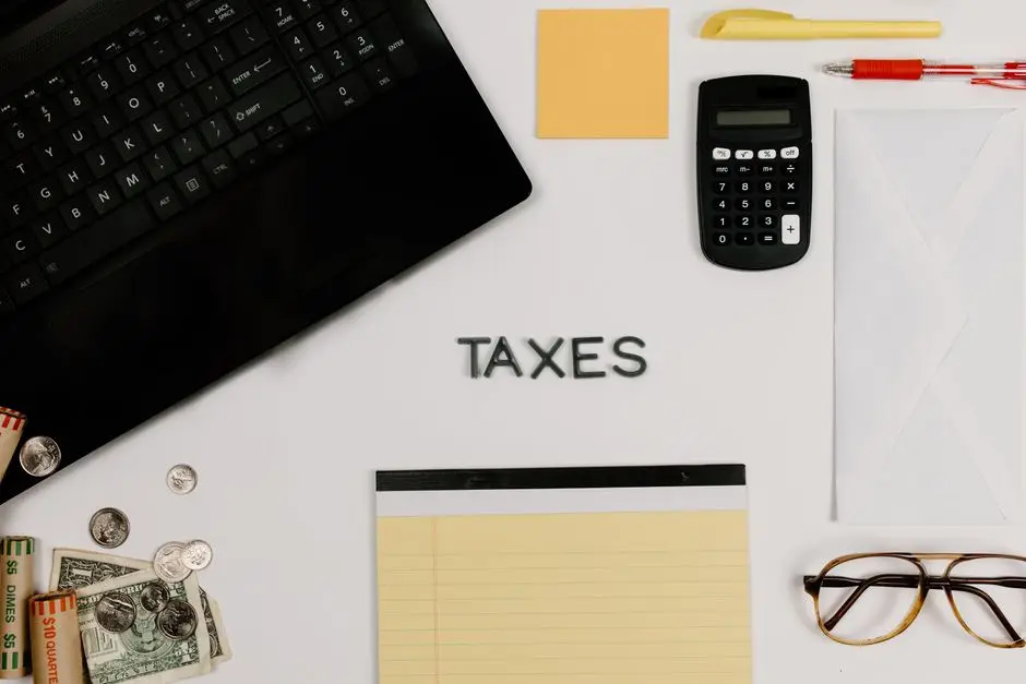 Organized office supplies for managing taxes, featuring a calculator, keyboard, and notepad.