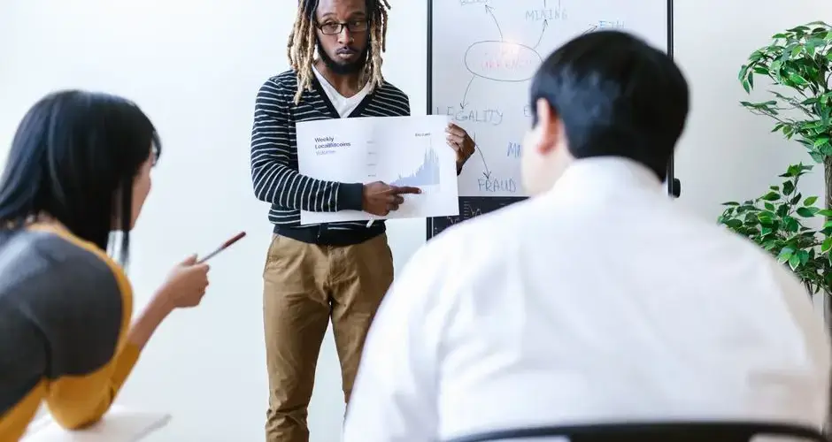 Business team discussing cryptocurrency and blockchain strategies in an office setting with a focus on financial growth.