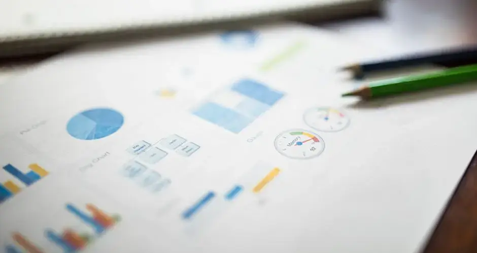 Illustration of a business financial report featuring various charts and graphs on paper.