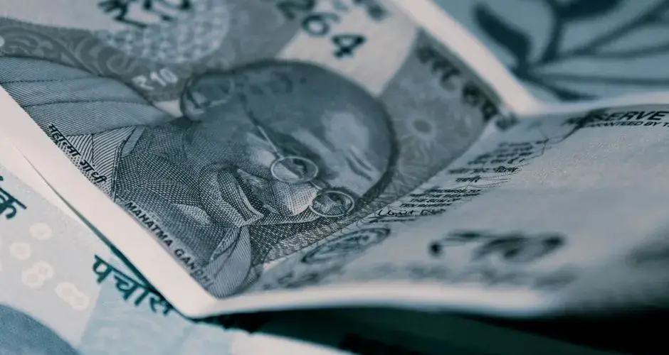 Detailed close-up of Indian Rupee banknotes with iconic Gandhi portrait, emphasizing economy and currency themes.