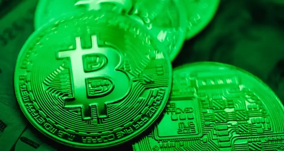 Close-up of green-illuminated Bitcoin coins representing digital currency and blockchain technology.