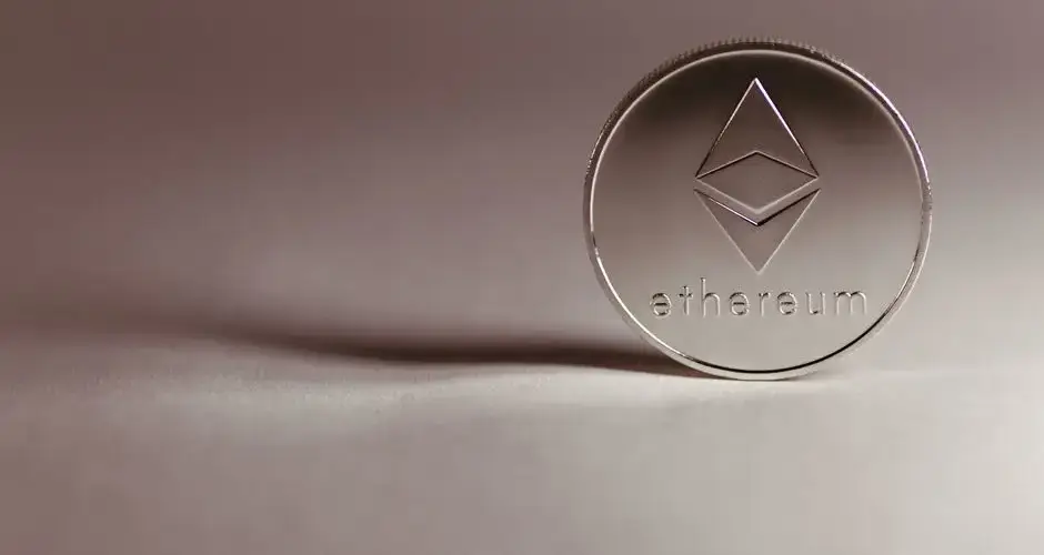 Close-up of a silver Ethereum coin symbolizing digital currency and blockchain technology.