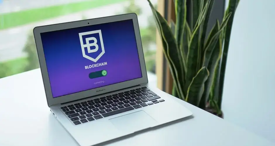 A modern laptop on a desk showing a blockchain interface, ideal for cryptocurrency topics.