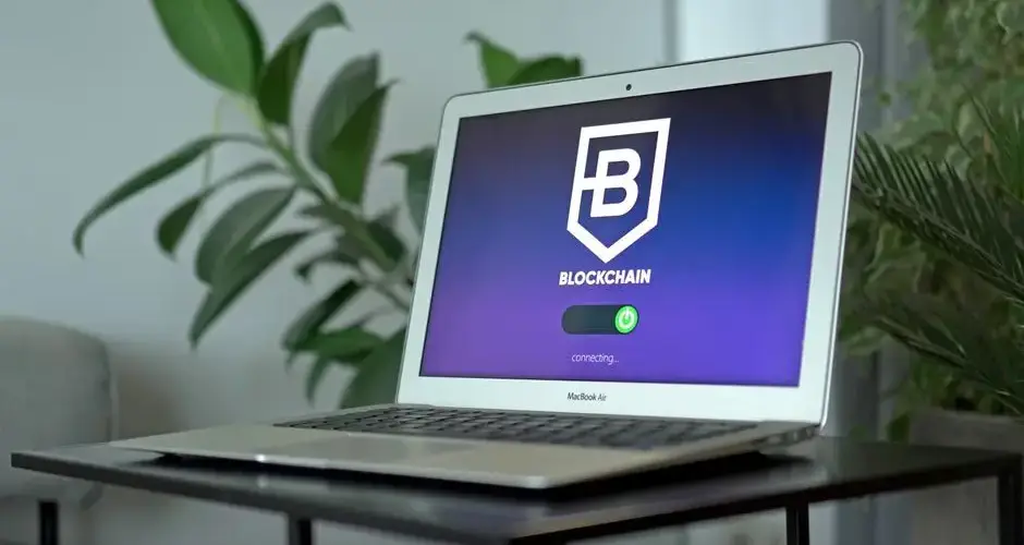 A sleek laptop showing a blockchain interface on a desk, ideal for technology and finance themes.