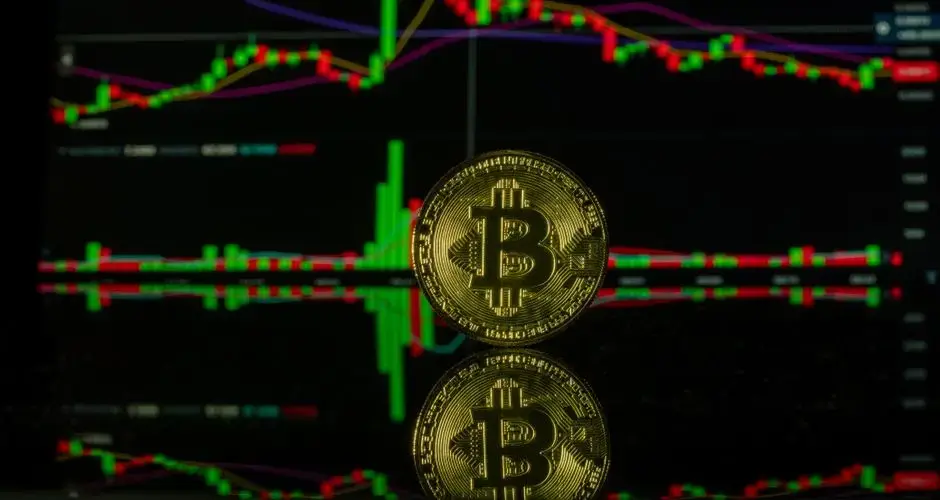 Bitcoin coin against a trading chart background showcasing market trends. Captured in Valencia.