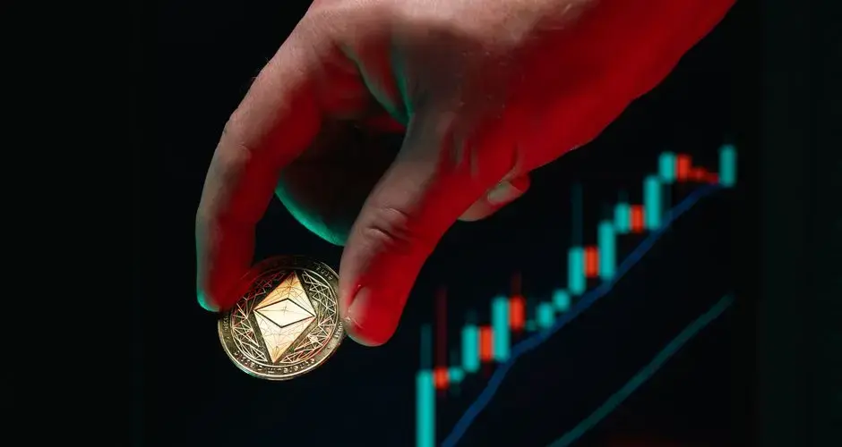 A hand holding an Ethereum coin against a rising stock market graph, symbolizing cryptocurrency growth.