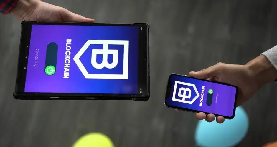 Smartphone and tablet displaying blockchain app interface, indicating tech connectivity.