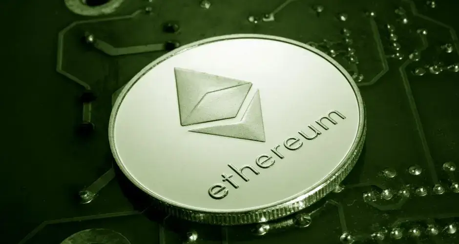 Close-up of an Ethereum coin placed on a circuit board, symbolizing digital currency technology.