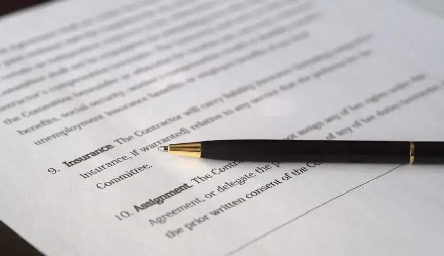 Close-up image of a business contract and pen, signed and ready for agreement.