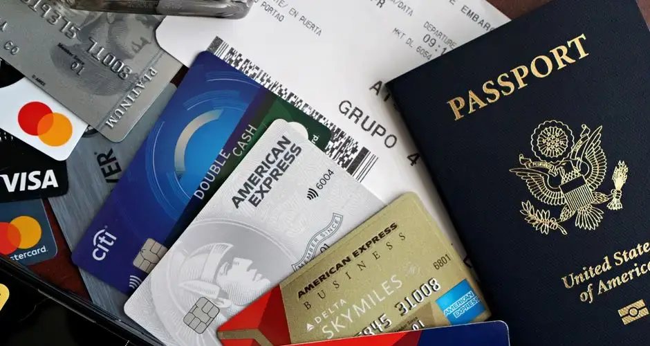 A collection of travel essentials including a passport, credit cards, and a boarding pass. Ideal for travel and finance concepts.