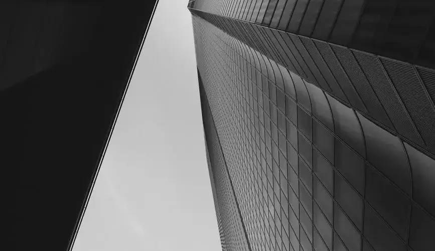 Low angle view of a modern skyscraper in Tokyo, showcasing abstract architectural design.