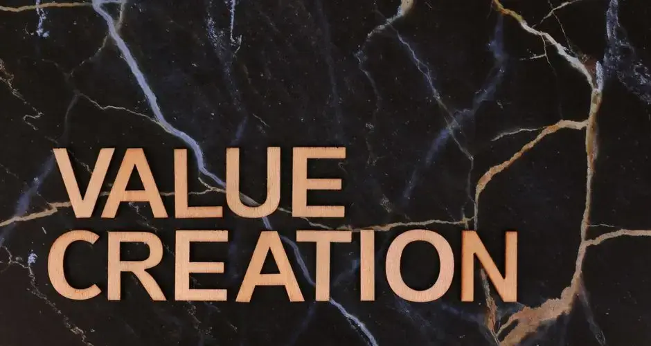 Wooden letters spelling 'Value Creation' on dark marble background, perfect for business themes.