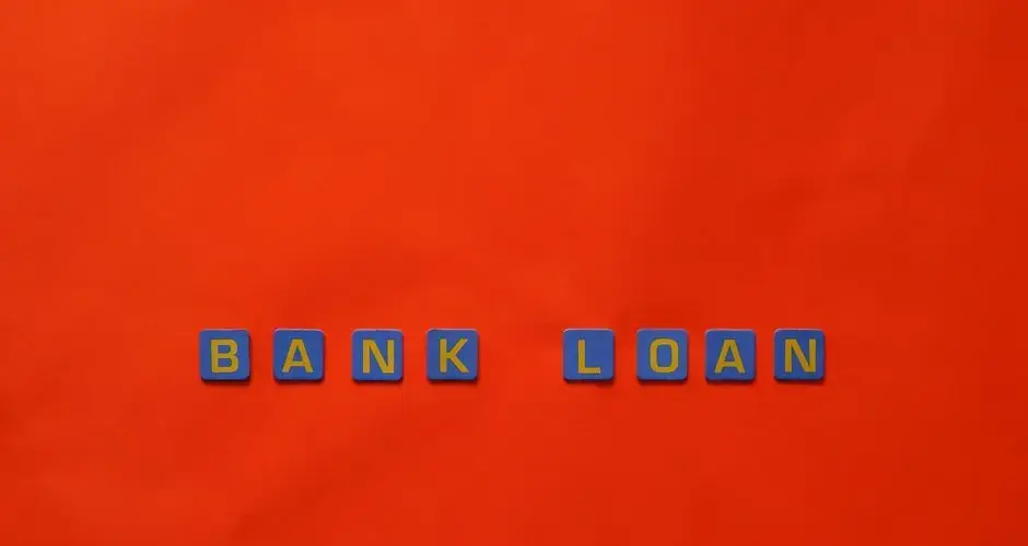 Letters forming 'Bank Loan' on a vibrant red surface, ideal for finance themes.