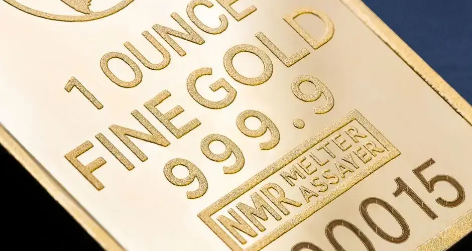 Detailed close-up of a 1 ounce fine gold bar with inscriptions, ideal for finance and investment themes.