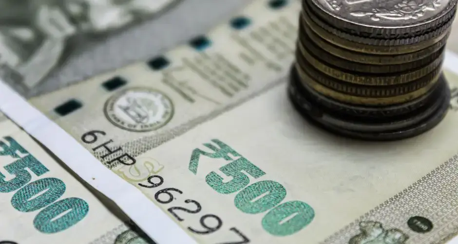 Detailed view of Indian rupees and stacked coins, representing currency and finance.