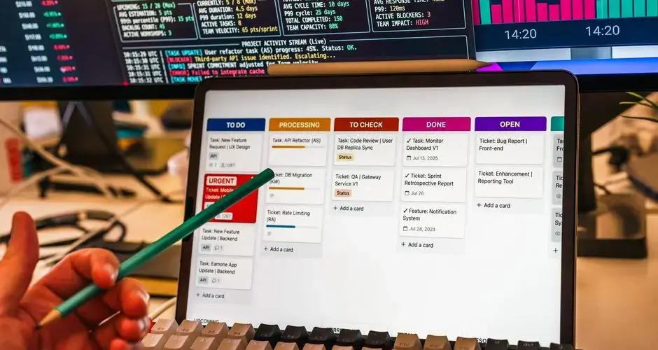Detailed view of a business workflow setup with tablet and multiple screens displaying data charts.