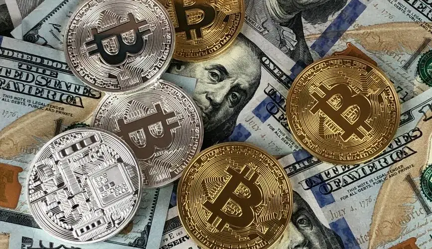 Close-up of bitcoins and US dollar bills symbolizing modern finance and cryptocurrency.