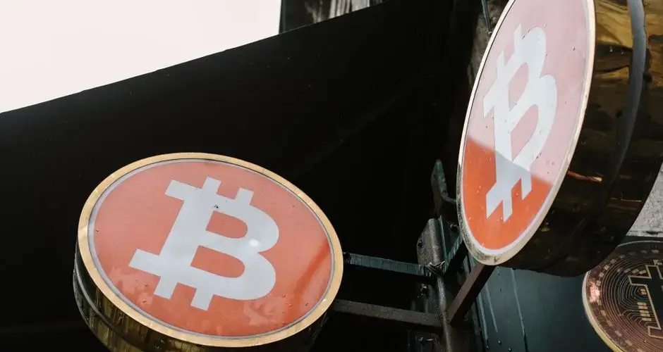 Close-up view of outdoor bitcoin symbol signs, reflecting modern cryptocurrency trends.