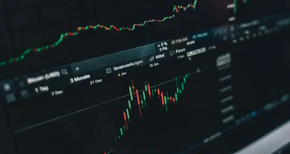 Close-up of a digital market analysis display showing Bitcoin and cryptocurrency price trends.