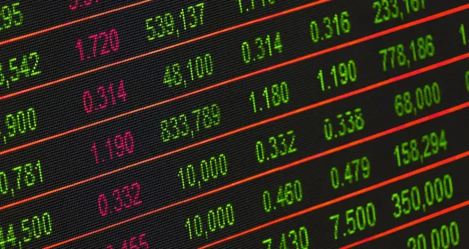 Close-up of a digital stock market data display showing colorful financial numbers and trends.