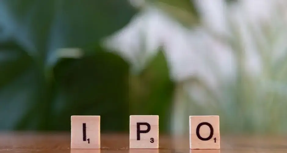 Wooden letter blocks spelling IPO on a table, symbolizing investment opportunities.