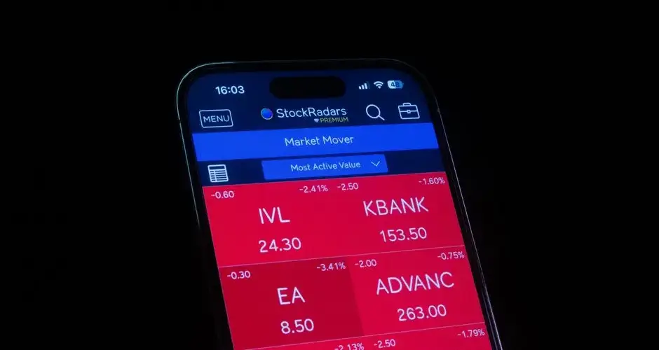 Close-up of a smartphone displaying a stock market app showing red losses.