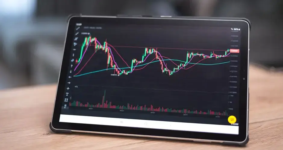 Close-up of a tablet showing financial graphs and trends. Ideal for finance and technology themes.