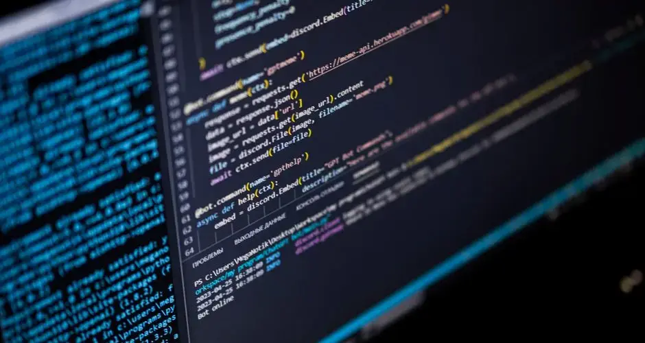 Close-up of a computer screen displaying HTML, CSS, and JavaScript code
