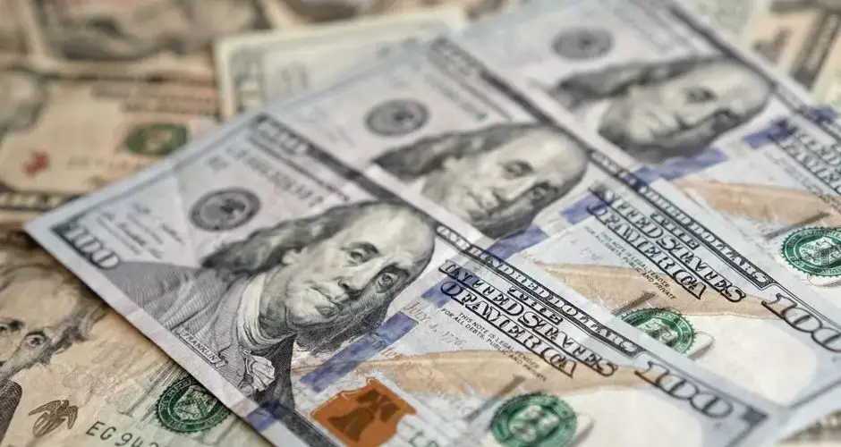 Detailed view of US dollar banknotes showcasing currency and investment themes.