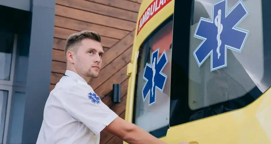 Paramedic preparing ambulance for immediate medical assistance. Emergency response visualized.